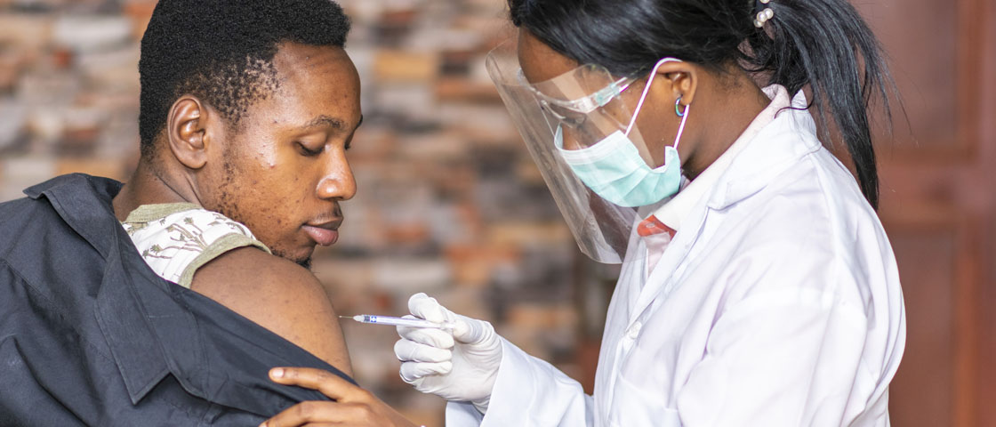 medical personnel administers a vaccine to a patient